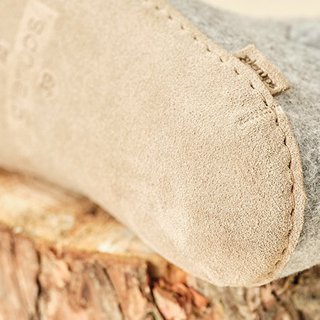 Close-up of gray slipper with leather sole
